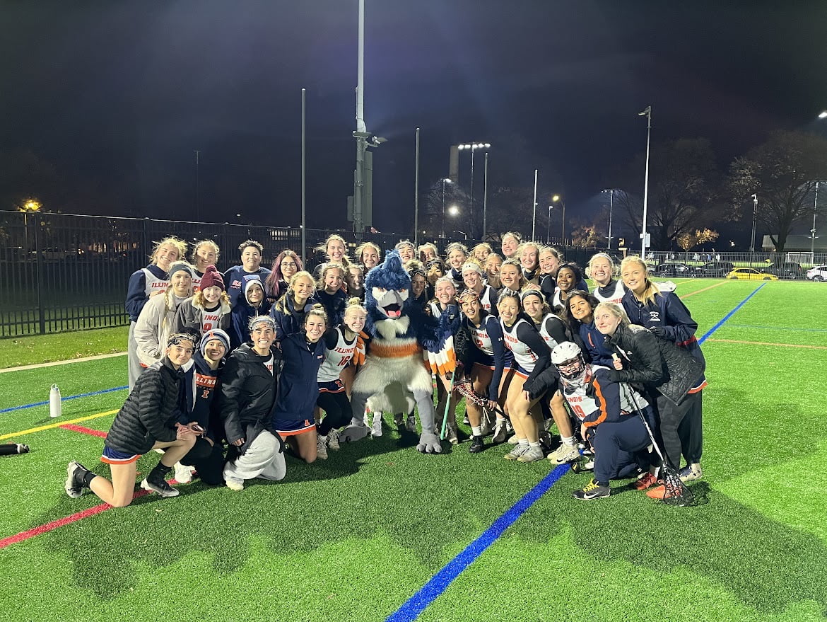 The Belted Kingfisher posing together with the women's Lacrosse team