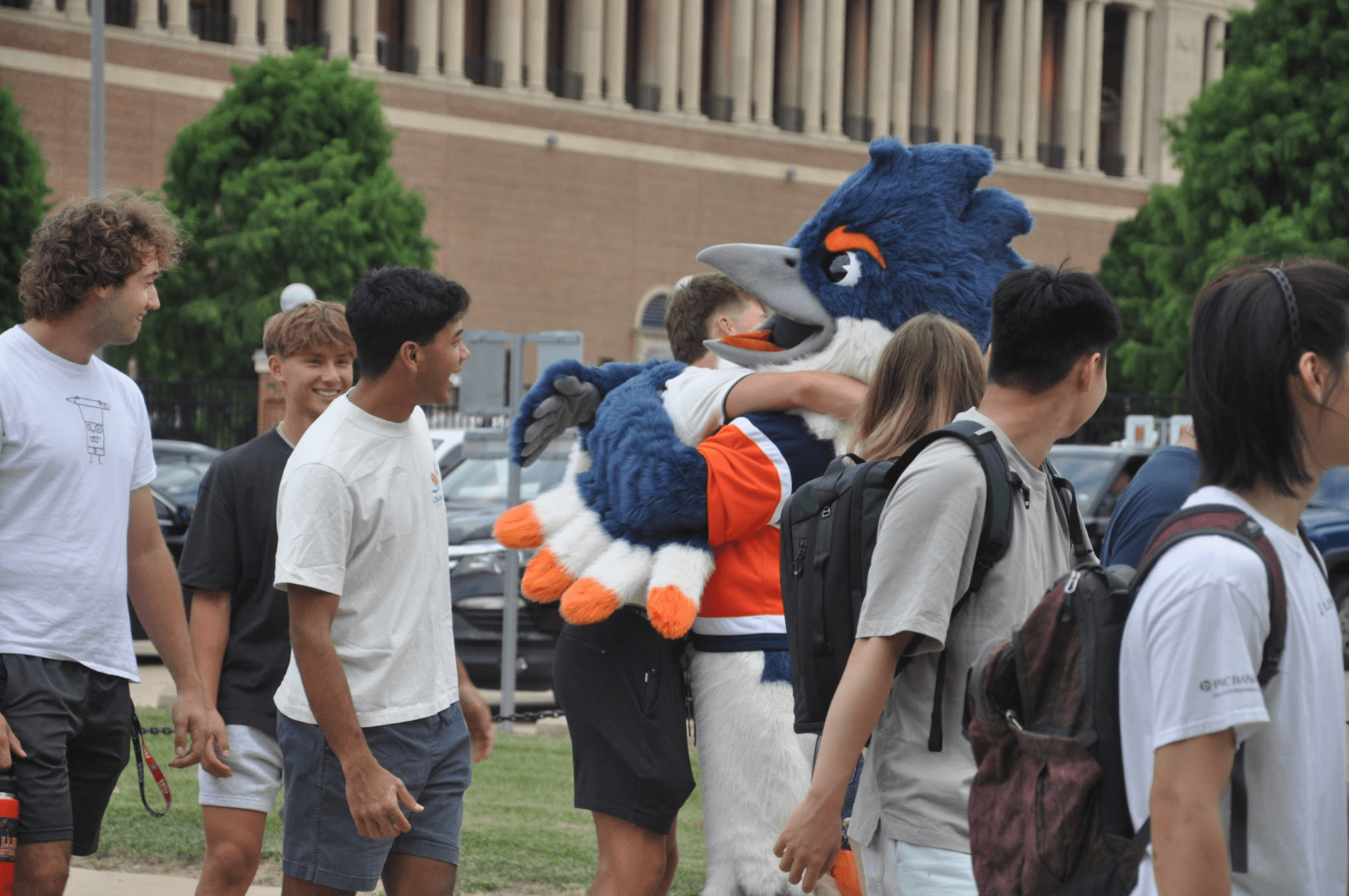 A student hugging the Belted Kingfisher