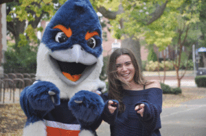 Belted Kingfisher and a student pointing towards the camera