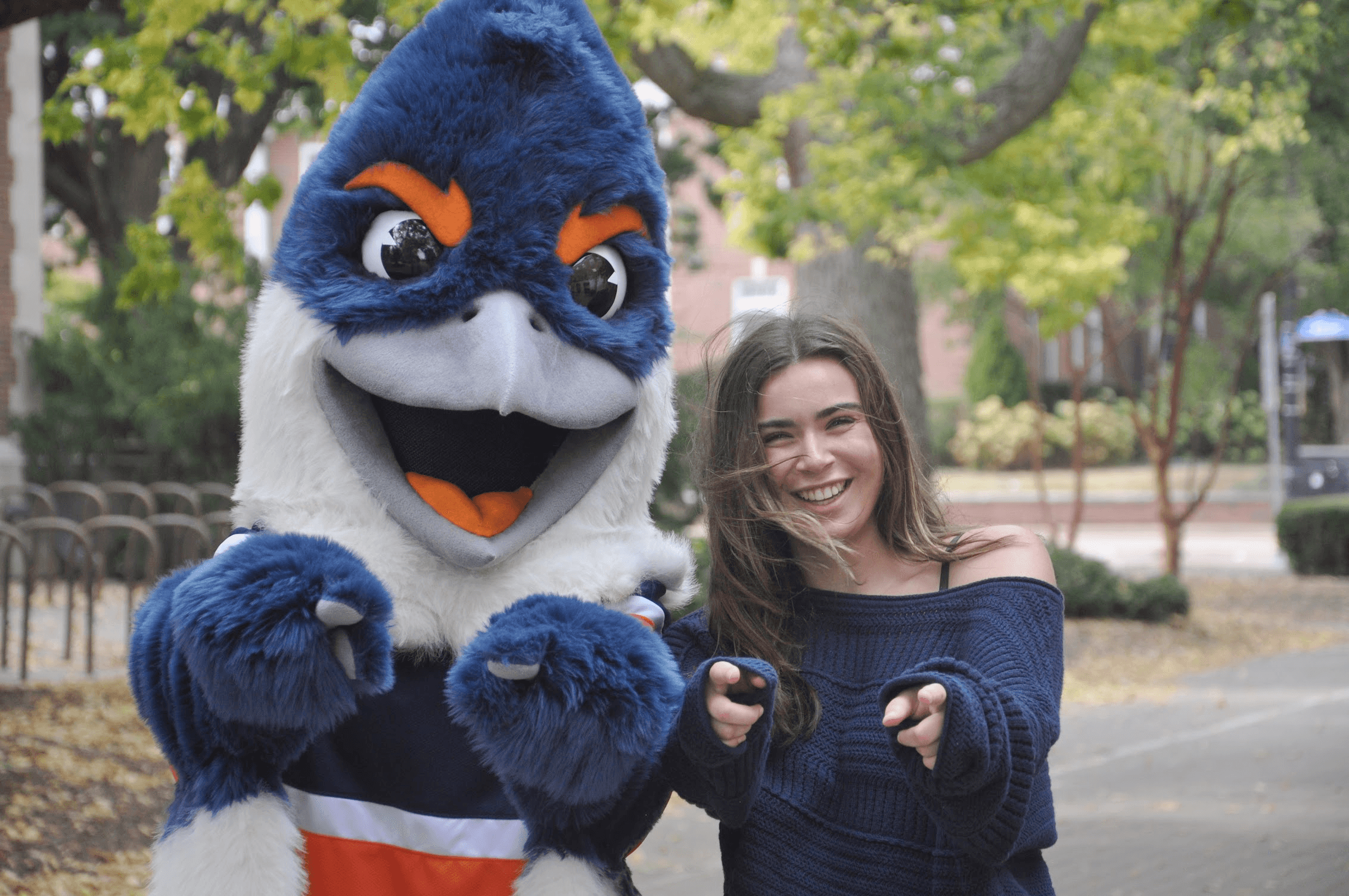 Belted Kingfisher and a student pointing towards the camera
