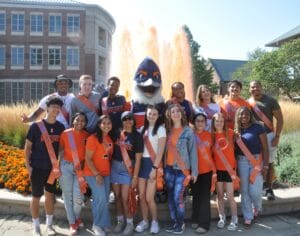 Belted Kingfisher posing with the Homecoming Court in front of an orange-dyed fountain
