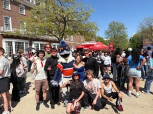Belted Kingfisher posing together with many students in music concert attire