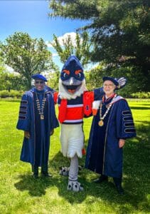 Belted Kingfisher posing between former Chancellor Robert Jones and President Tim Killeen