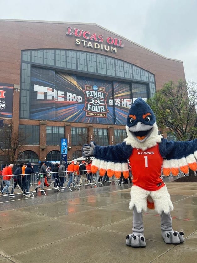 The Belted Kingfisher mascot posing in front of Lucas Oil Stadium before the Final Four game